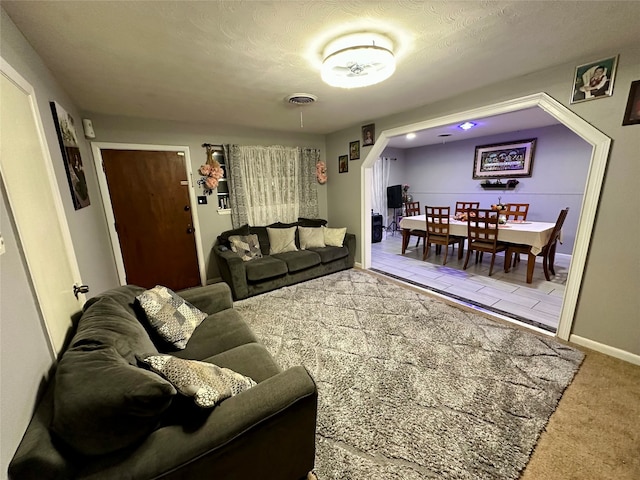 carpeted living room with a textured ceiling