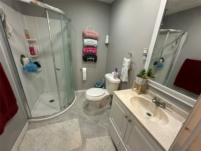 bathroom featuring vanity, toilet, tile patterned floors, and a shower with door