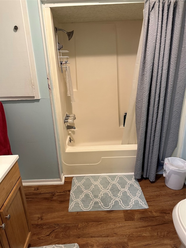 full bathroom with vanity, toilet, shower / bath combination with curtain, and hardwood / wood-style floors