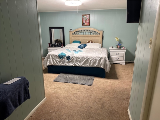 bedroom with wood walls and carpet