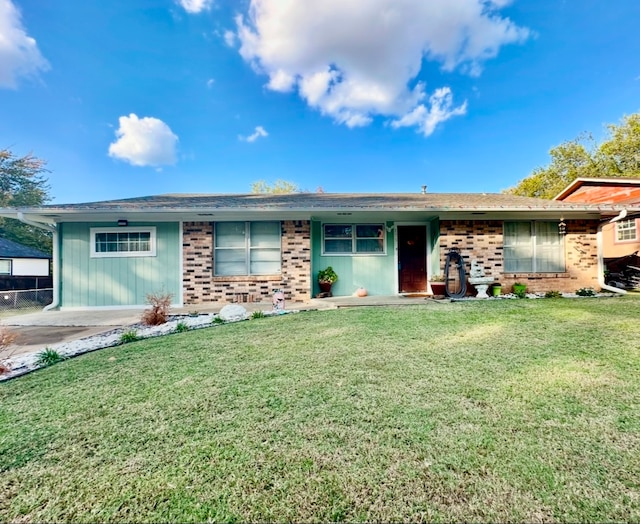 ranch-style home with a front lawn and a carport