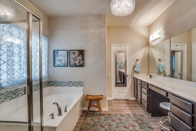 bathroom with vanity, a chandelier, and shower with separate bathtub