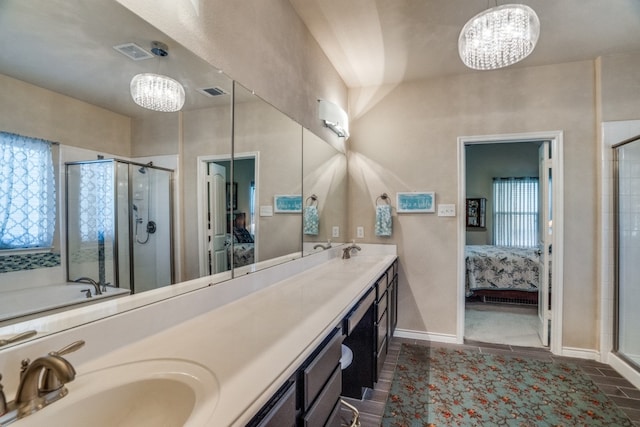 bathroom featuring a shower with door, a chandelier, vanity, and tile patterned flooring