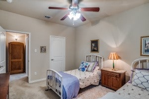 bedroom with light colored carpet and ceiling fan