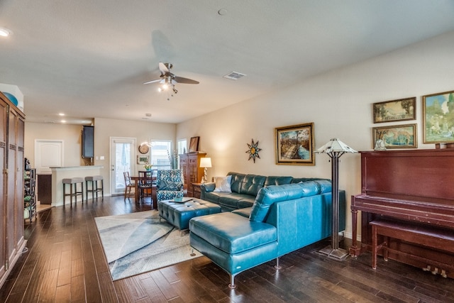 living room featuring dark hardwood / wood-style floors and ceiling fan