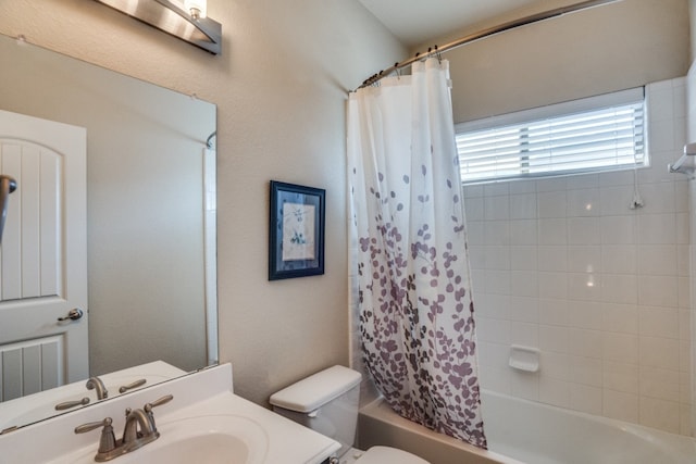 full bathroom with toilet, shower / bath combo with shower curtain, and sink