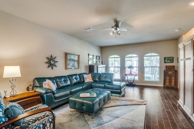 living room featuring ceiling fan and dark hardwood / wood-style flooring