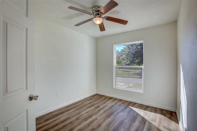 unfurnished room with ceiling fan and dark hardwood / wood-style flooring