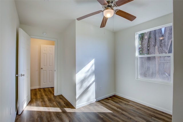 spare room featuring ceiling fan and dark hardwood / wood-style floors