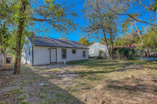 back of property featuring a yard