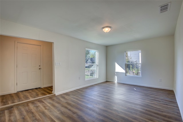 spare room with dark hardwood / wood-style floors