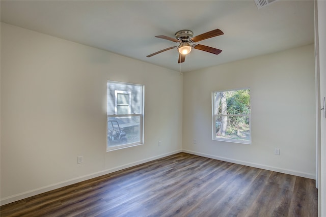 unfurnished room with dark wood-type flooring and ceiling fan