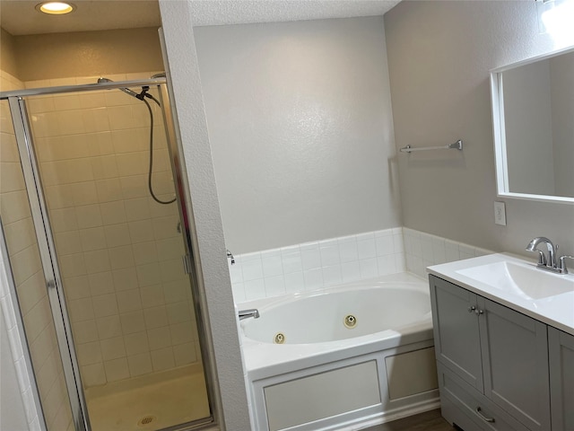 bathroom with vanity and separate shower and tub