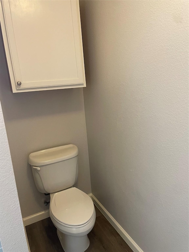 bathroom with wood-type flooring and toilet