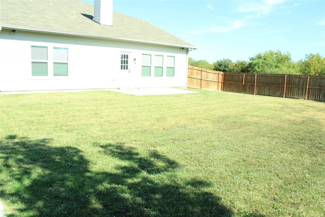 rear view of house featuring a lawn and a patio area