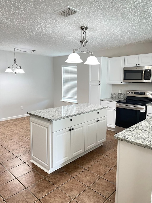 kitchen featuring white cabinetry, appliances with stainless steel finishes, a center island, and pendant lighting