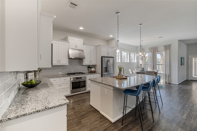 kitchen featuring a kitchen island, dark hardwood / wood-style floors, sink, white cabinets, and appliances with stainless steel finishes