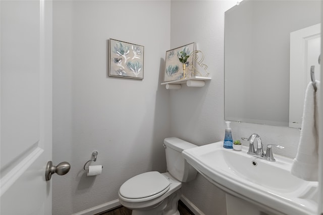 bathroom featuring toilet and sink