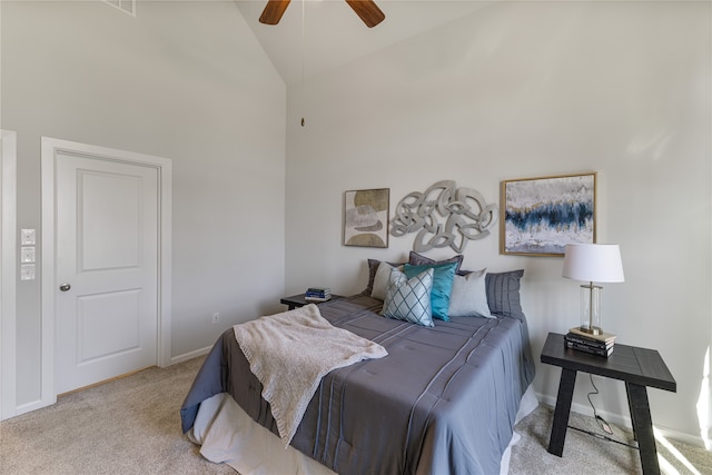 bedroom with light colored carpet, high vaulted ceiling, and ceiling fan