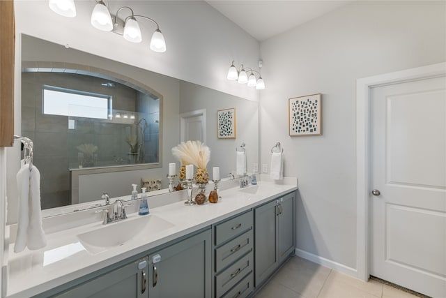 bathroom featuring vanity, a tile shower, and tile patterned flooring