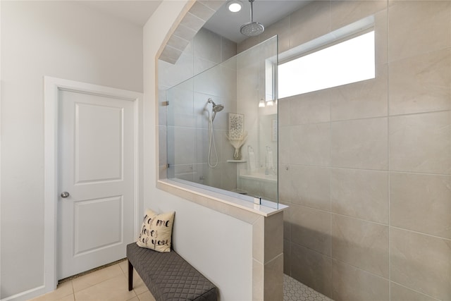 bathroom featuring a tile shower and tile patterned flooring