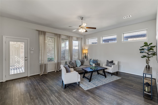 living room featuring ceiling fan and dark hardwood / wood-style flooring