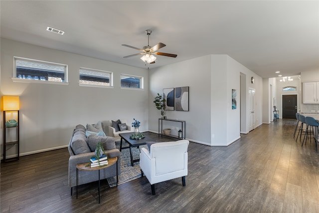 living room with a healthy amount of sunlight, ceiling fan, and dark hardwood / wood-style flooring