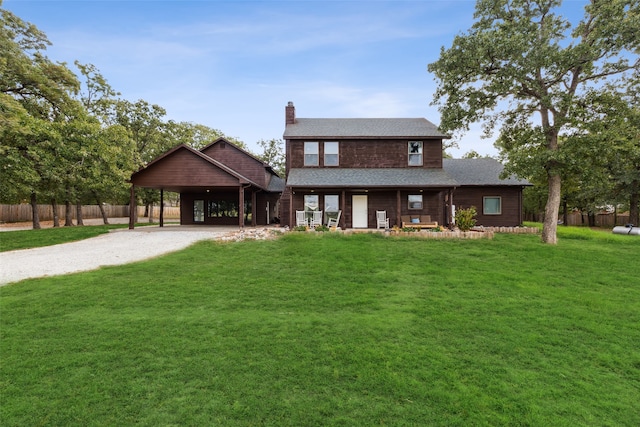 view of front of property featuring a carport and a front lawn