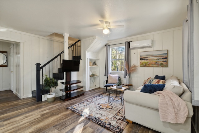 living room with ceiling fan, a wall mounted AC, and dark hardwood / wood-style flooring