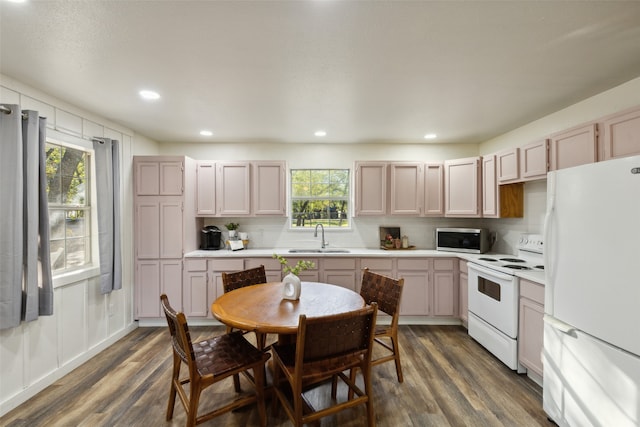 kitchen featuring white appliances, sink, backsplash, and dark hardwood / wood-style flooring