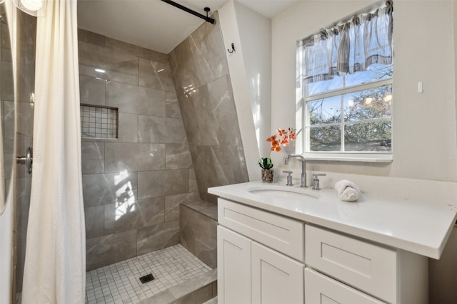 bathroom with walk in shower and vanity