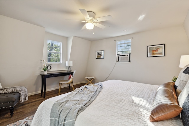 bedroom featuring ceiling fan, multiple windows, cooling unit, and dark hardwood / wood-style flooring