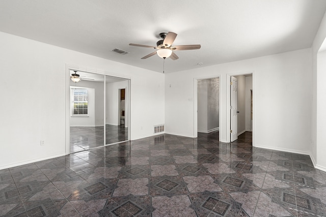 spare room featuring ceiling fan and a textured ceiling