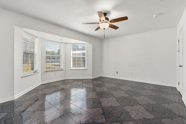 unfurnished room featuring a textured ceiling and ceiling fan