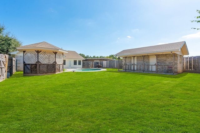 view of yard with a fenced in pool