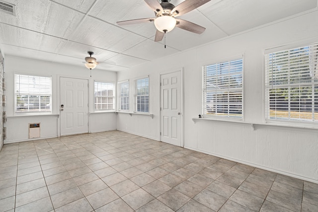 unfurnished room with light tile patterned floors and a wealth of natural light