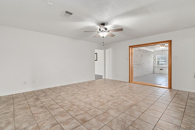 unfurnished living room featuring ceiling fan and light tile patterned floors