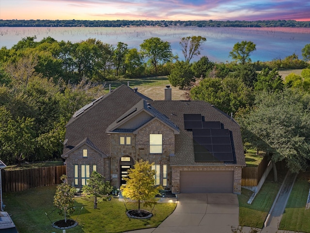 aerial view at dusk with a water view