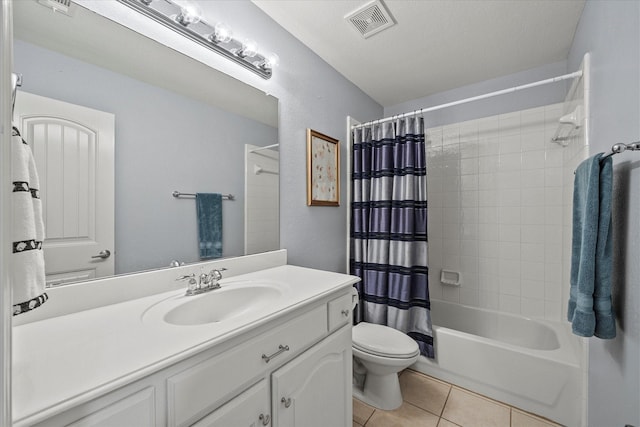 full bathroom with tile patterned flooring, vanity, toilet, a textured ceiling, and shower / bath combo with shower curtain