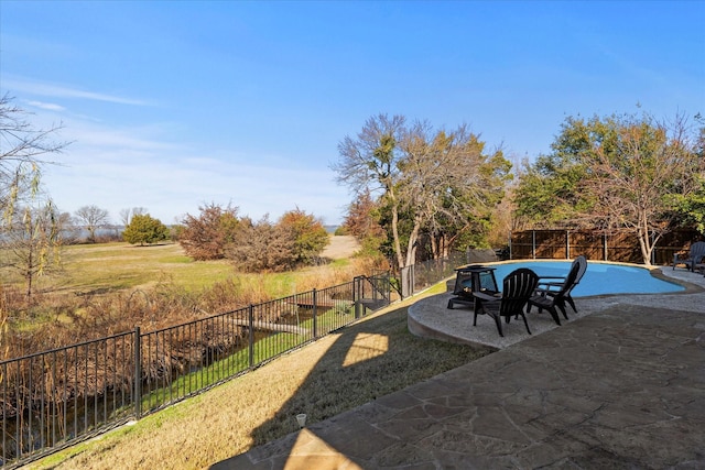 view of yard featuring a fenced in pool and a patio