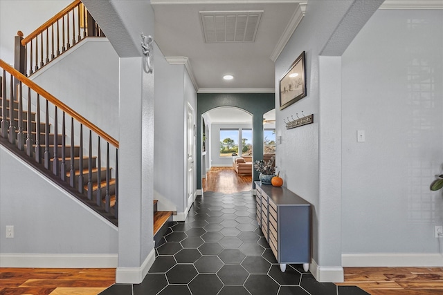 interior space featuring dark tile patterned floors and crown molding