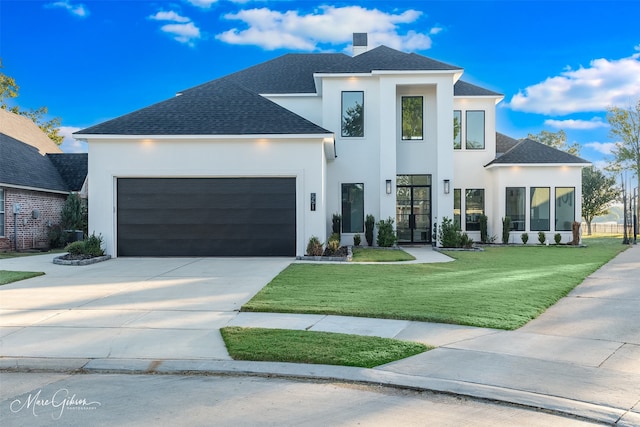 contemporary home featuring a front lawn and a garage