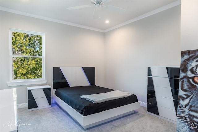 carpeted bedroom featuring crown molding and ceiling fan