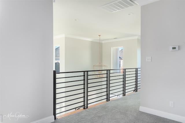 corridor with crown molding and carpet flooring