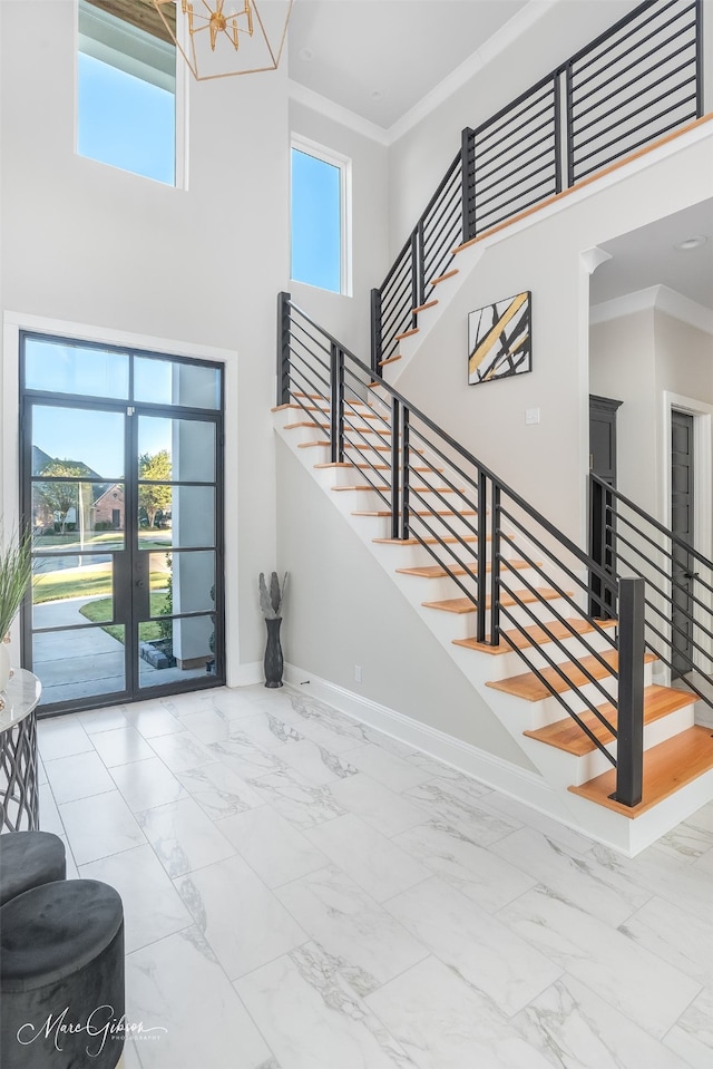 entryway featuring a towering ceiling and a wealth of natural light