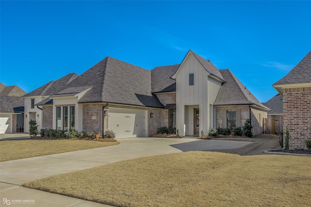 french provincial home with a front lawn and a garage