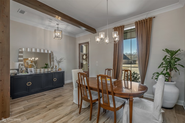 dining space with light hardwood / wood-style floors, beamed ceiling, an inviting chandelier, and ornamental molding