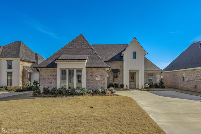 french country style house featuring a front lawn