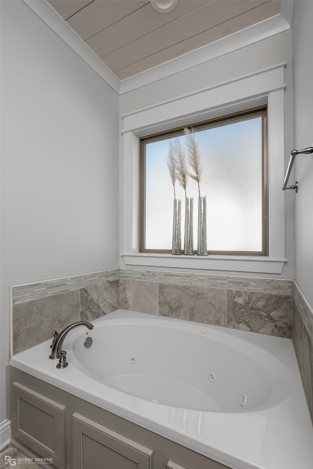 bathroom with a bathing tub and ornamental molding