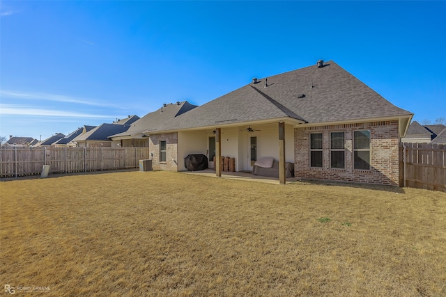 rear view of property with a patio area and a lawn